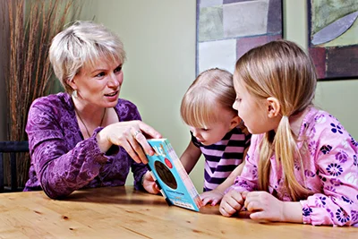 Child practising speech sounds with a clinician