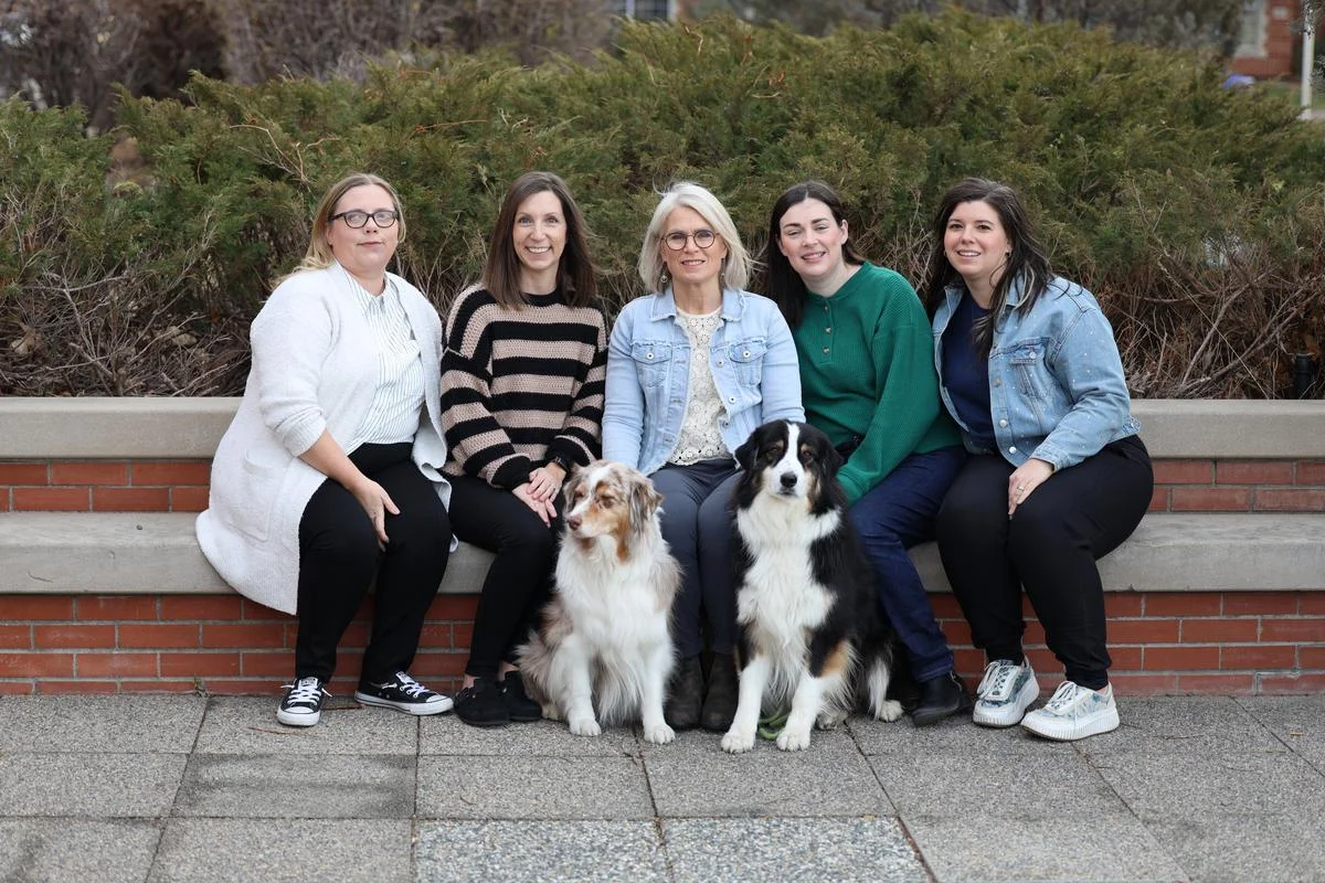 Small-group training session with educators taking notes and discussing strategies